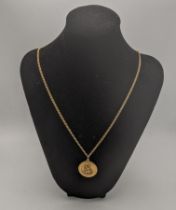 A 9ct gold St Christopher pendant and a 9ct gold necklace 18.65g Location: If there is no
