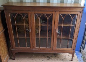 An early 20th century mahogany three door glazed display cabinet on square tapering short legs 121.