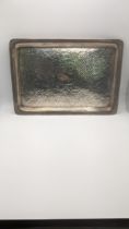 A Synyer and Beddoes silver tray, hallmarked Birmingham 1904, having a hammered decorated base, 30.