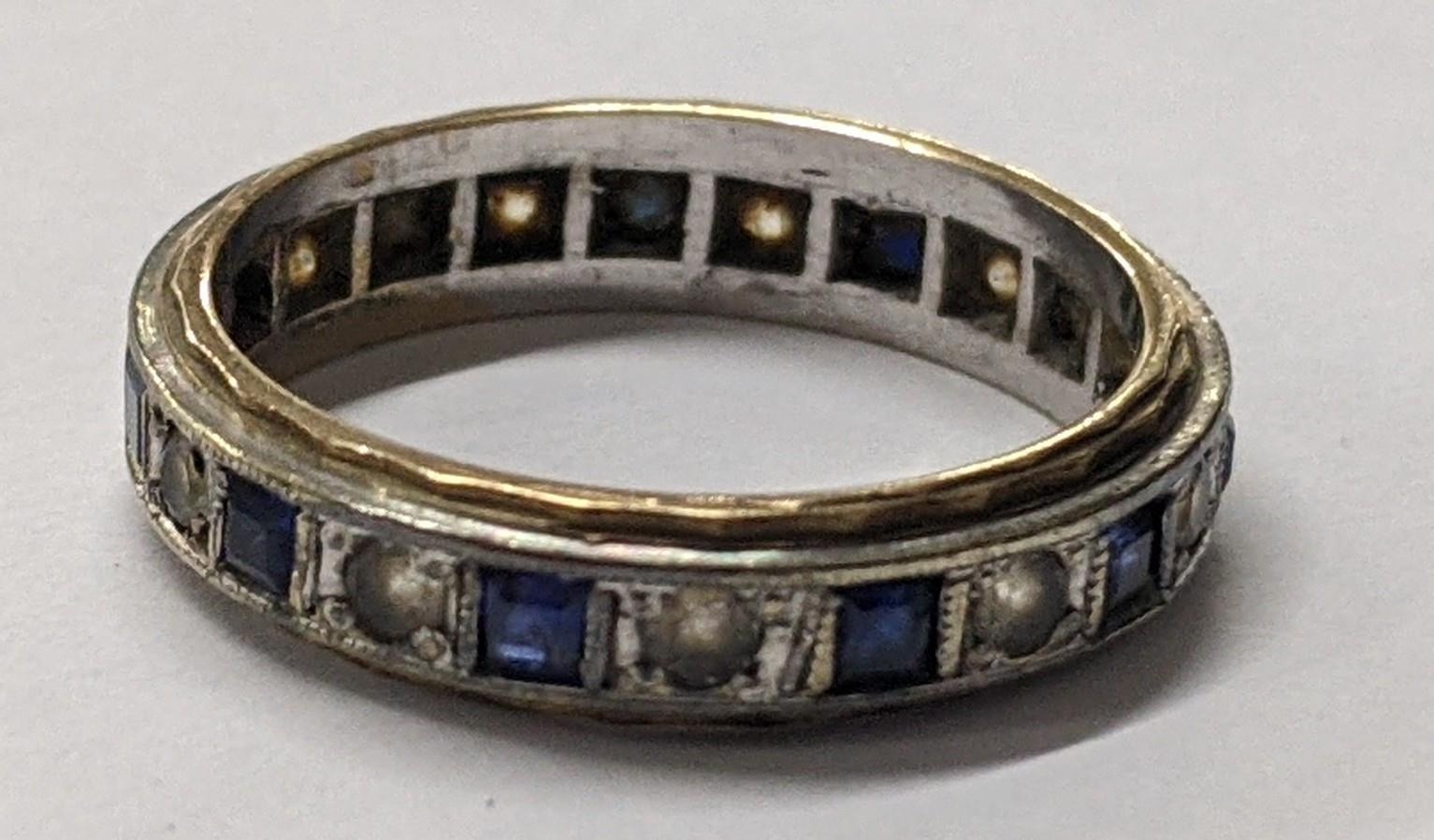 A 9ct white and yellow gold sapphire eternity ring, 3.1g Location: If there is no condition report