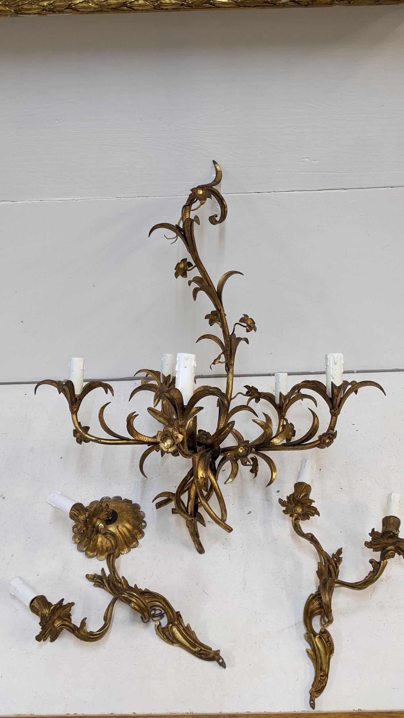 A gilt metal chandelier fashioned as leaves and a pair of similar wall lights Location: If there