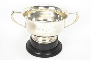 A George V silver twin handled presentation bowl, Birmingham 1925, having a flared rim, engraved