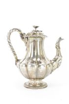 A late 19th century Indian silver coffee pot, hallmarks for Calcutta 1860-1914, having a flower