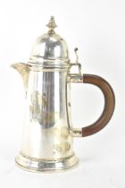 A George VI silver hot water jug by Wakely & Wheeler, hallmarked London 1939, having a domed top lid