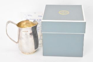 An Elizabeth II silver cream jug, by Anthony Hawksley, hallmarked London 1991, the base having a