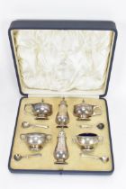 A George V silver cased cruet set by Mappin & Webb, hallmarked Birmingham 1928, consisting of two