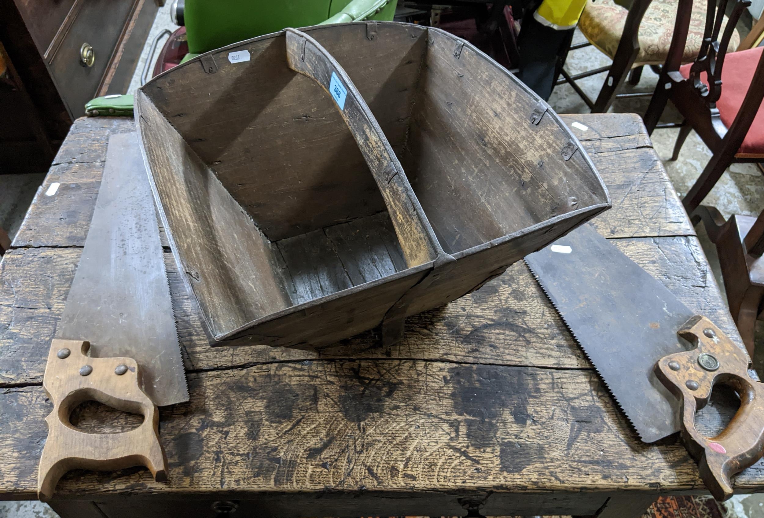 A wooden Chinese rice basket with wrought iron straps, along with two woodworking saws Location: