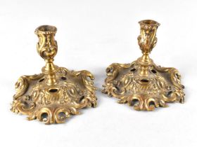 A Pair of Brass Candlesticks with Ornate Scrolled and Pierced Base and Acanthus Holders, 7.5cms High
