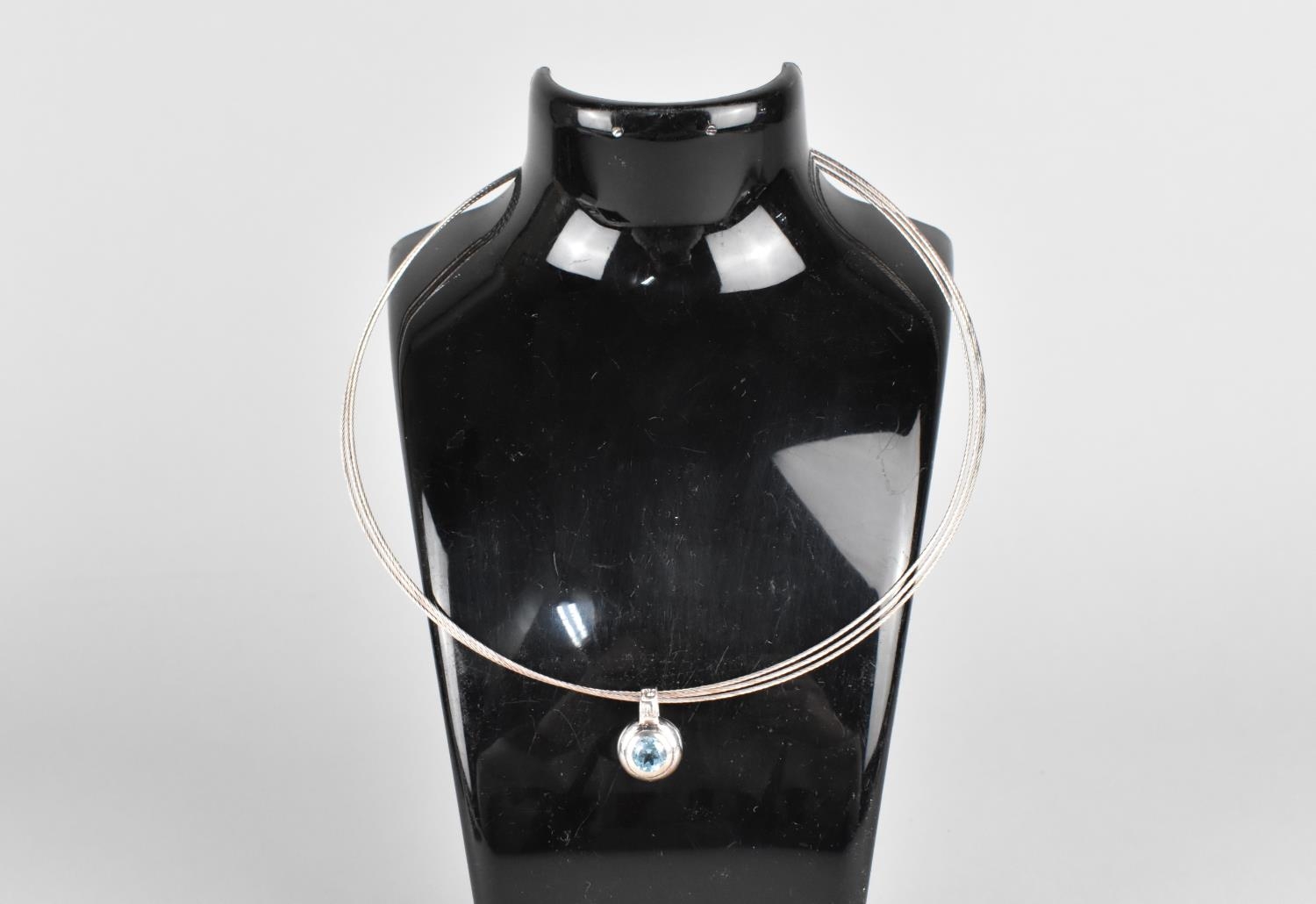 A Silver Triple Hoop Necklace with Topaz and Silver Pendant
