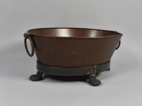 A Cast Metal Foot Bath with Twin Ring Handles on Four Claw Feet, 58cms Wide