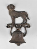 A Cast Metal Wall Hanging Bell with Dog Motif, 20cms High