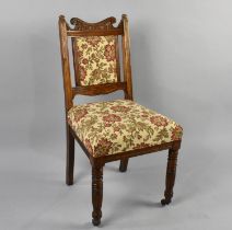 An Early 20th Century Upholstered Oak Framed Chair with Carved Back on Turned Castor Supports