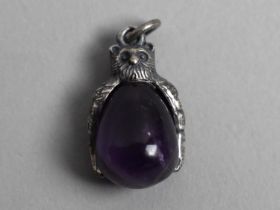 A Silver and Purple Stone Pendant in the Form of an Owl