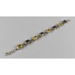A Silver, Lemon and Smokey Quartz Sectional Bracelet, Eight Emerald Cut Stones Raised in Four Claws,