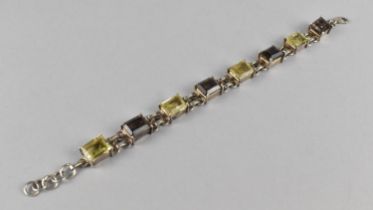 A Silver, Lemon and Smokey Quartz Sectional Bracelet, Eight Emerald Cut Stones Raised in Four Claws,