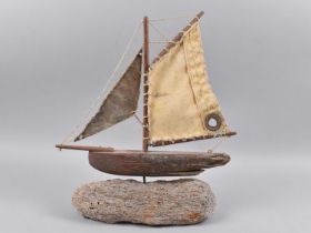 A Wooden Model of a Boat on Driftwood Base, 36cms High