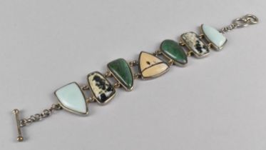 An Eastern Style Silver, Dalmatian Jasper, Larimar and Malachite Style Stone Sectional Bracelet with