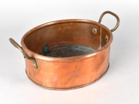 A Copper Twin Handled Cooking Pot of Oval Form, 26cms Wide