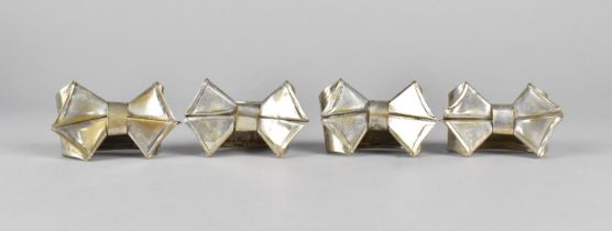 A Set of Four Silver Plated Napkin Rings in the Form of Bows