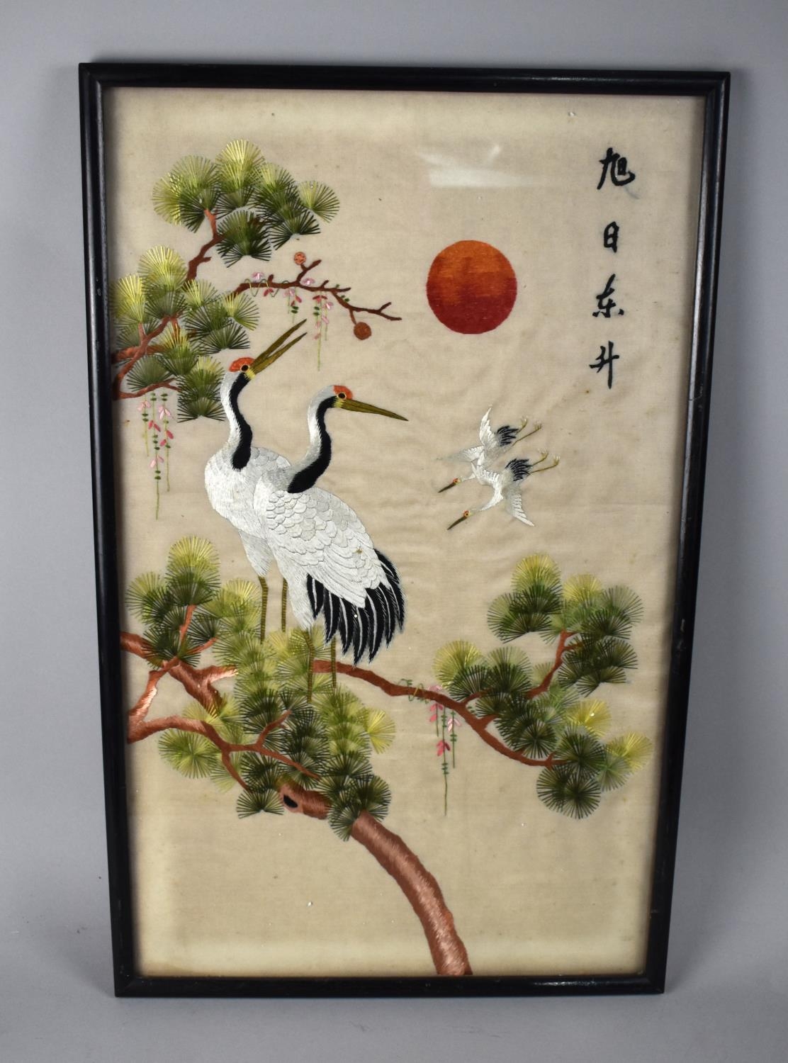 A Framed Oriental Embroidery Depicting Cranes