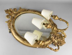 A 19th Century Gilt Oval Wood and Plaster Wall Mirror with Tri-Candle Sconces Converted to