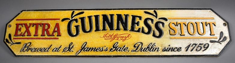 A Reproduction Painted Cast Metal Plaque for Guinness Extra Stout, 56cms Wide