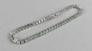 A Green Stone and Silver Tennis Bracelet Comprising Round Cut Stones in Four Claw Mounts