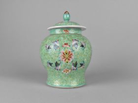 A Chinese Porcelain Enamel Vase and Cover Decorated with Scrolls, Flowers and Bats on Blue Ground,