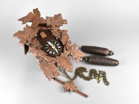 A Wooden Cased Cuckoo Clock, Complete with Weights