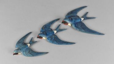 A Set of Three Graduated Cold Painted Ceramic Swallow Wall Plaques, Inscribed to Back 'England'