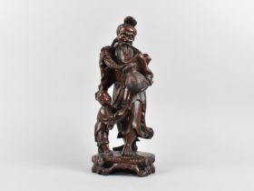 A Chinese Carving Depicting Elder with Child, 25cms High (Condition issues)