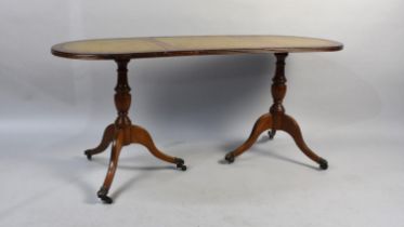 A Mahogany and Tooled Leather Topped Coffee Table on Turned Vase Supports and Coaster Feet, 114cms