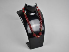 A Vintage Glass Necklace with Faceted Red Beads and Chain Glass Links