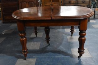 A Late Victorian Mahogany Pull Out Dining Table having Three Extra Leaves Extending to 344cms by