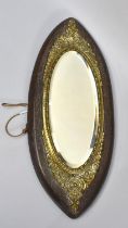 A Late Victorian/Edwardian Oval Oak and Ornate Brass Framed Mirror with Bevelled Glass, 52cms High