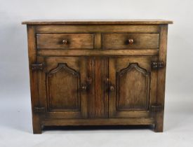 A Mid 20th Century Oak Sideboard with Two Drawers over Panelled Doors to Shelved Cupboard Base,