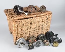 A Wicker Fishing Creel Containing Various Vintage Reels to include Bakelite Cased Penn No 78,