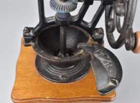 A Cast Iron and Wooden Base Coffee Grinder