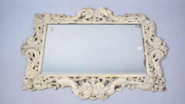 A Large Cream painted Carved Wooden Framed Wall Mirror, 106cms by 77cms