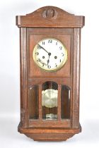 An Edwardian Oak Wall Clock, 62cms High