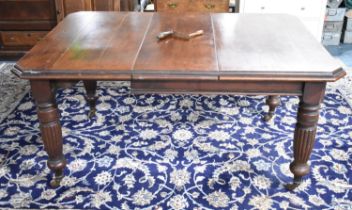 An Oak Wind Out Extending Dining Table on Turned Reeded Vase and Castor Supports, 151x105x72cms High