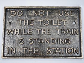 A Reproduction Cast Metal Railway Carriage Sign, 'Do Not Use The Toilet...', 29x19cms Plus VAT