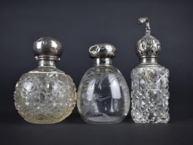 Two Vintage Silver Topped Scent or Dressing Table Bottle together with an Atomizer