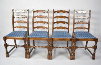 A Set of Four Oak Framed Dining Chairs