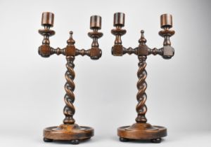 A Pair of Edwardian Two Branch Oak Candlesticks with Barley Twist Supports and Circular Tray Base,
