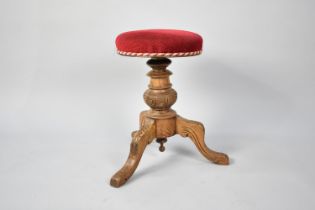 A Late Victorian/Edwardian Swivel Top Piano Stool on Carved Wooden Tripod Base