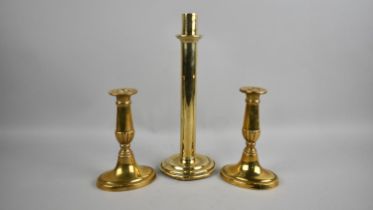 A Single 19th Century Heavy Brass Candlestick, 28cms High, together with a Pair of Brass