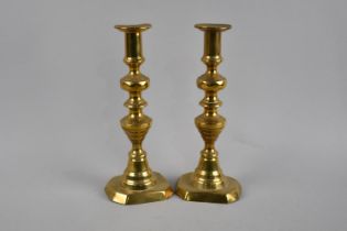 A Pair of 19th Century Brass Candlesticks with Pushers, One having Slightly Warped Base, 25cms High