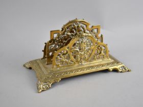 A French Brass Desktop Two Division Letter Rack with Four Scrolled Feet, 20cms Wide