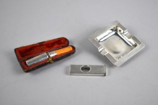 A Small Silver Ashtray, Silver Cigar Cutter and a Cased Silver and Amber Cheroot Holder